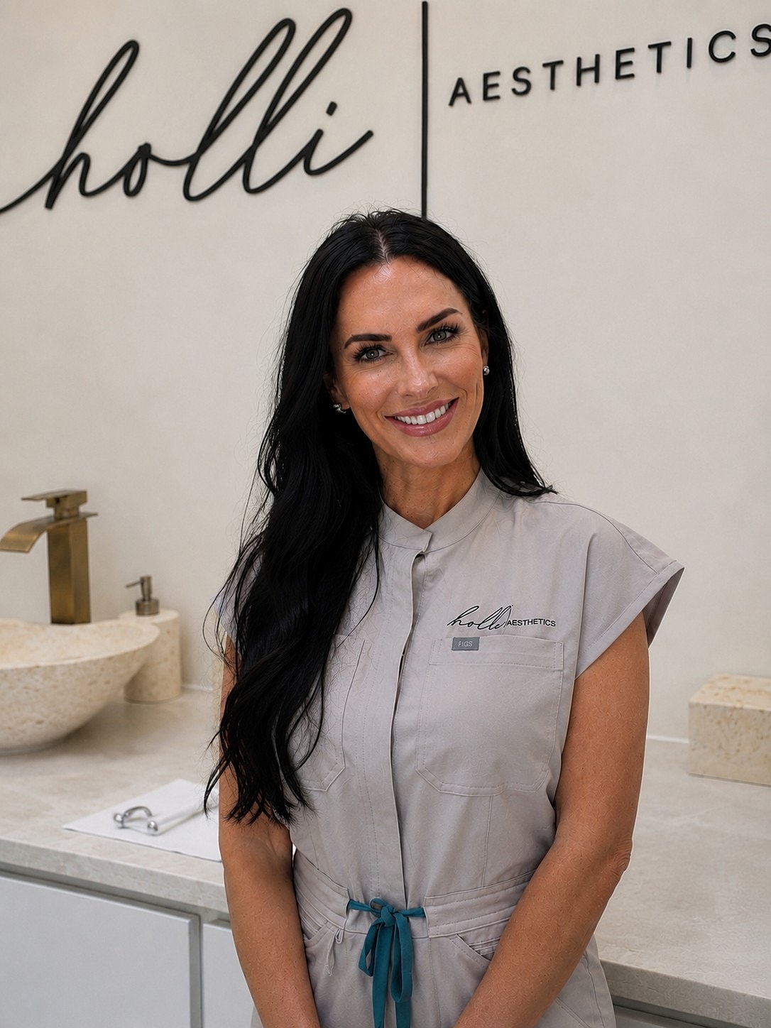 Aesthetician smiling at a beauty clinic.