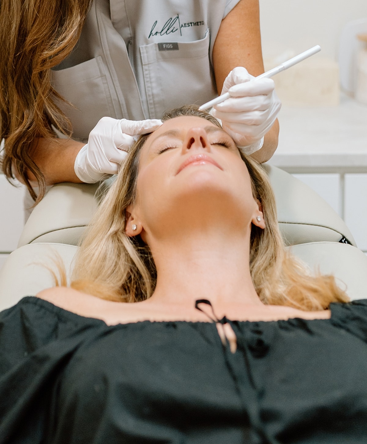 Aesthetic treatment procedure in progress on client.