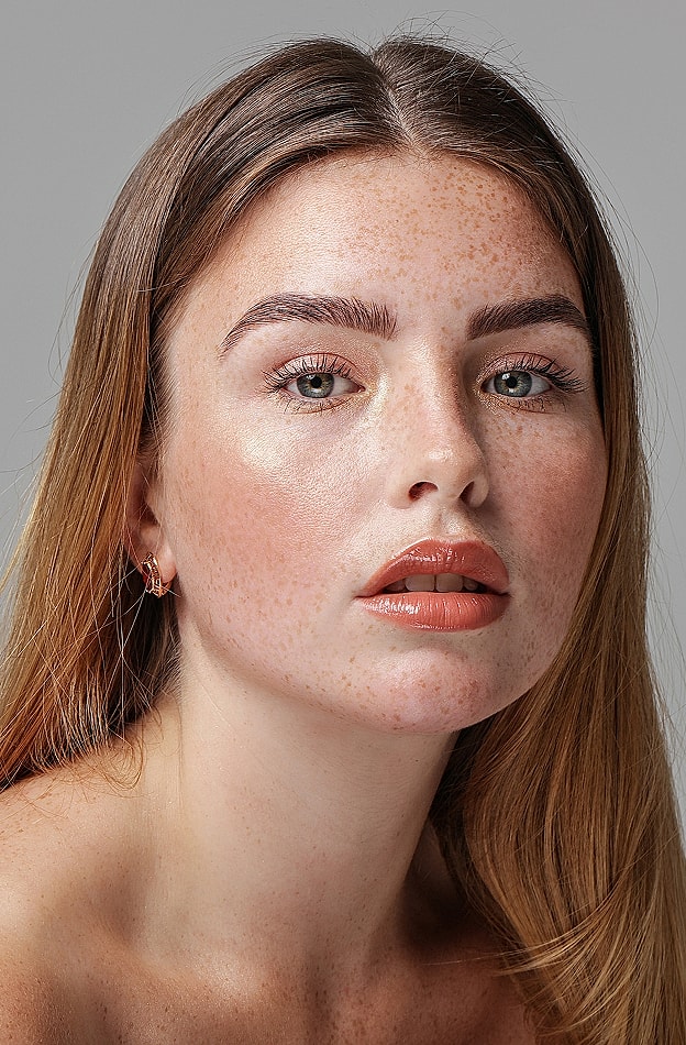 Portrait of a young woman with freckles.