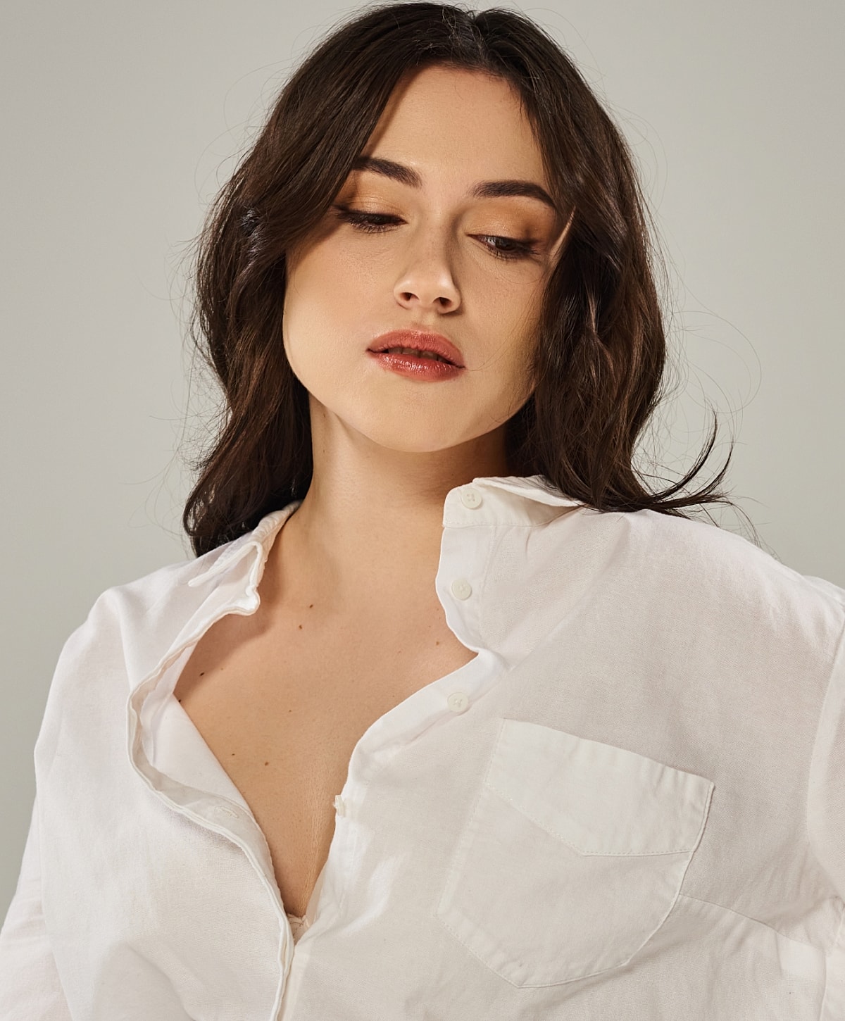 Woman in white shirt with soft makeup.
